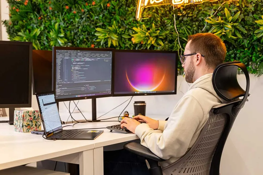 Cold Banana developer working at his desk on code.