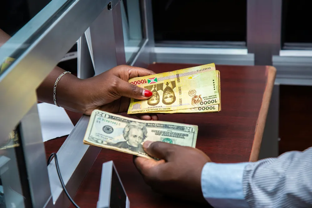 A person converting currency to USD