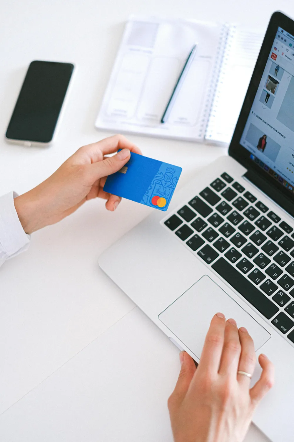 A person on their laptop typing in card details.