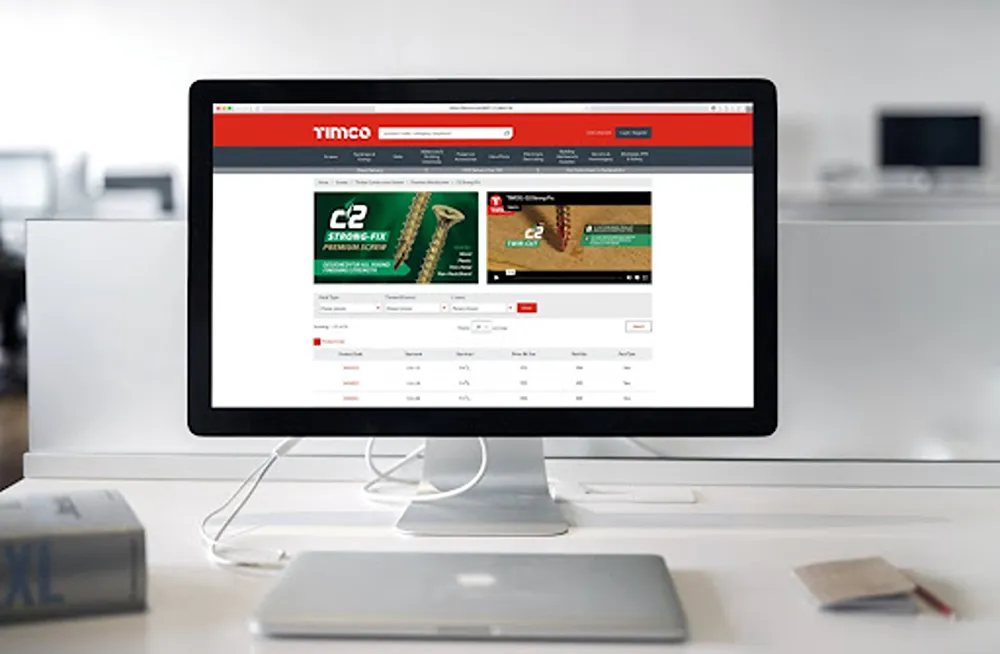 TIMCO website homepage on a desktop monitor in a home office.