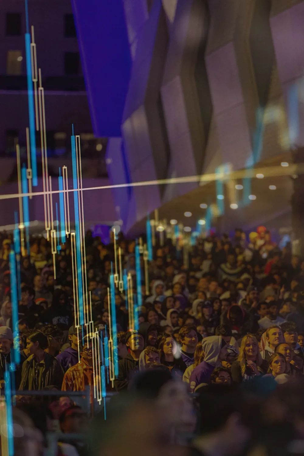 A photo of an audience, with an overlay of stock data.