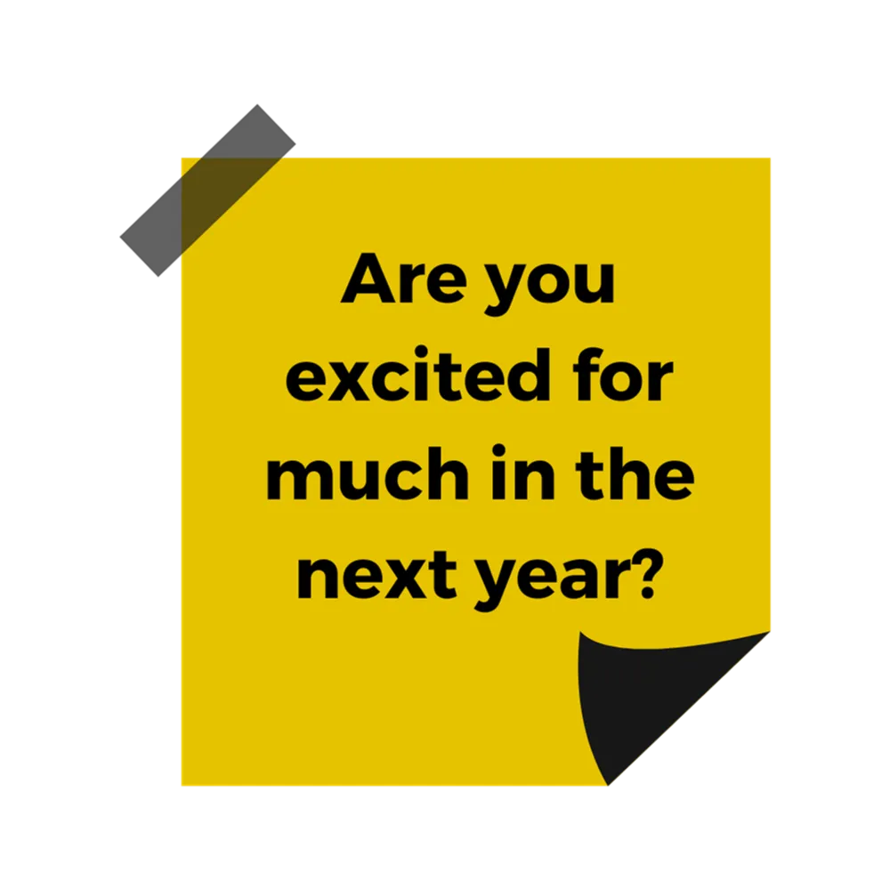 A yellow post it note with black text reading "Are you excited for much in the next year?"
