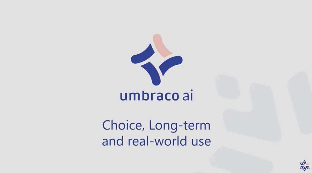 A slide from the Umbraco Winter Keynote 2026. In the middle is the Umbraco AI logo. Underneath this is the sub-heading "Choice, Long-term and real world use"