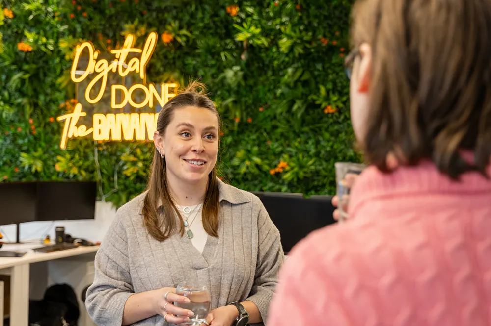 Two Cold Banana employees talking at the water cooler