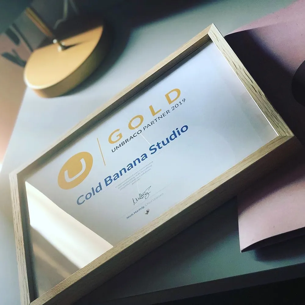 Cold Banana Umbraco Gold Partner Certificate in a frame on a desk.