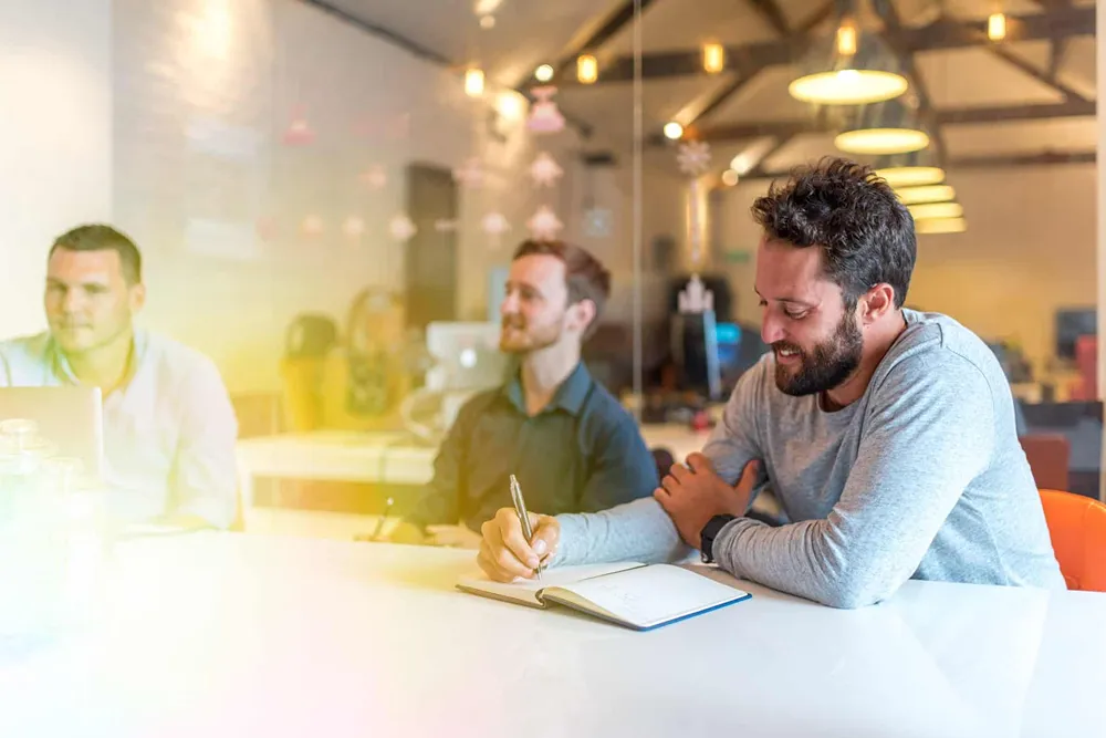 Three Cold Banana employees in a meeting.