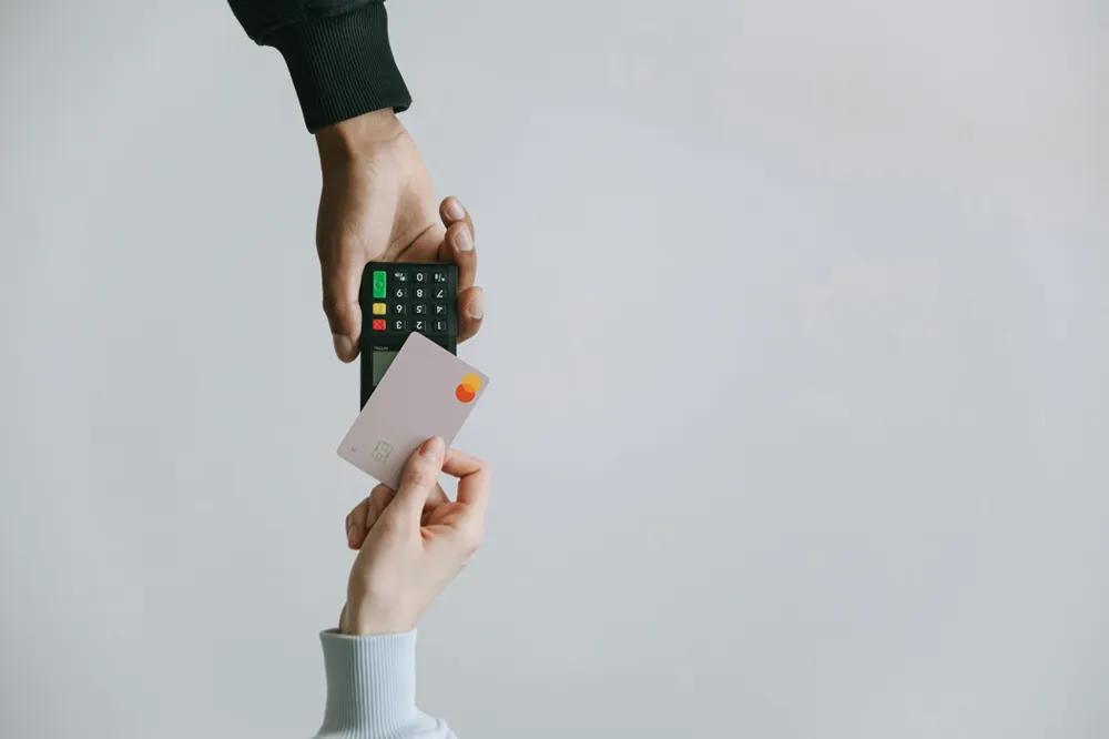 A person paying a fee with a debit card