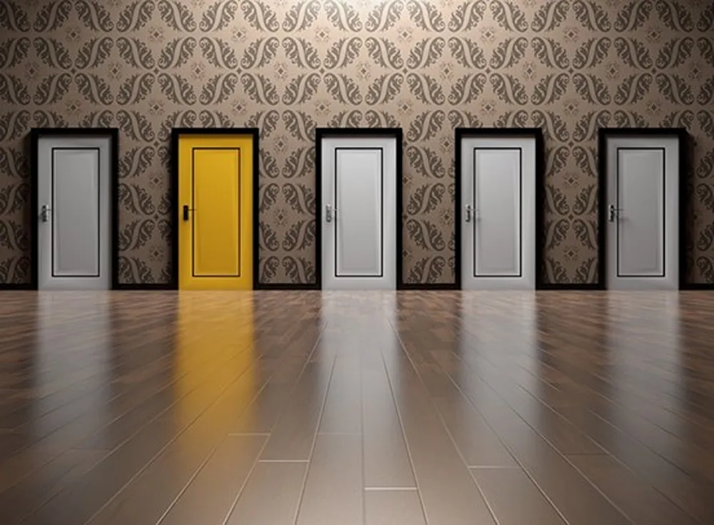 Several white doors, with the second to left door being bright yellow.