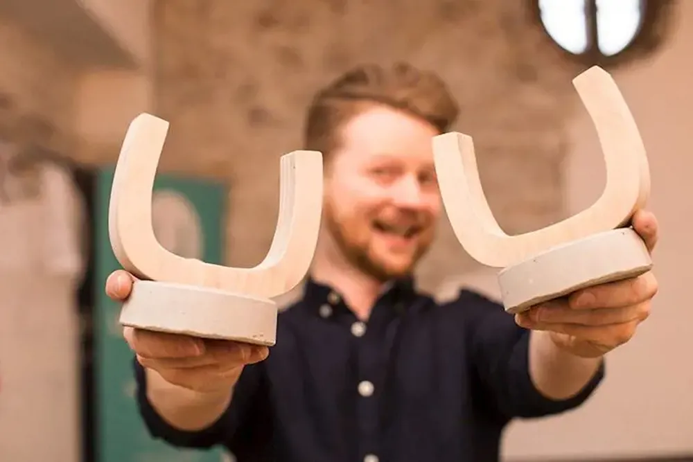 A man holding two Umbraco award trophies