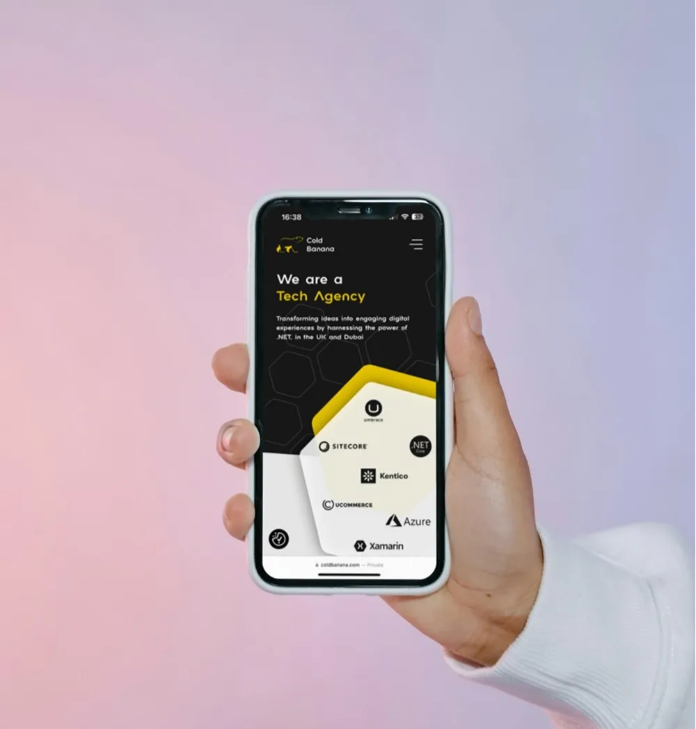 A hand holding a smartphone with the Cold Banana website on it.