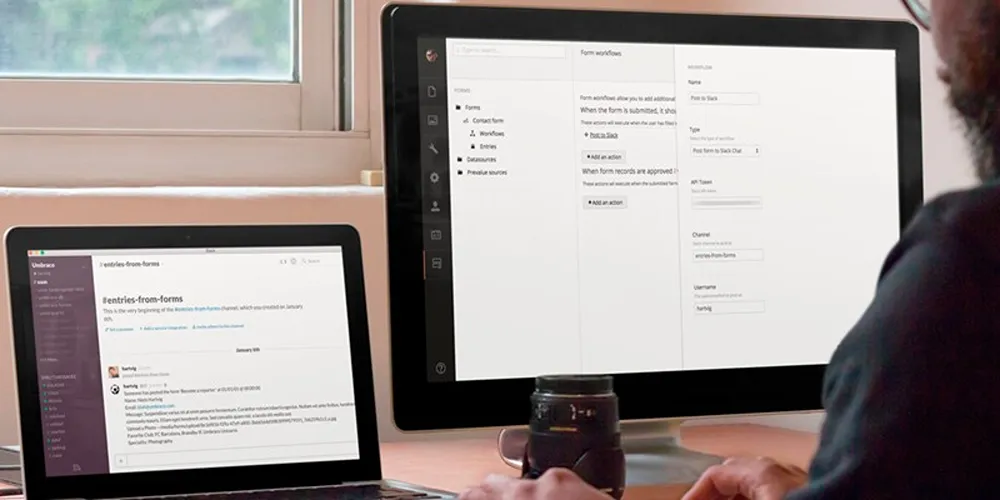 A person working at their desk with Slack on their laptop
