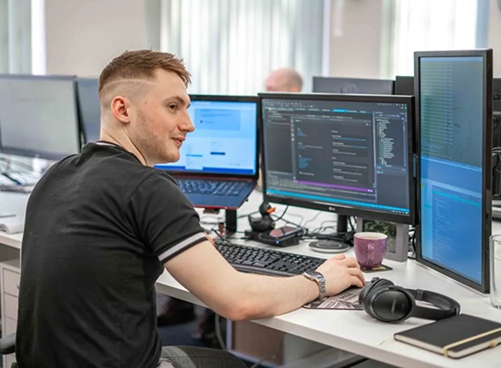 Ollie Storey working at his desk.