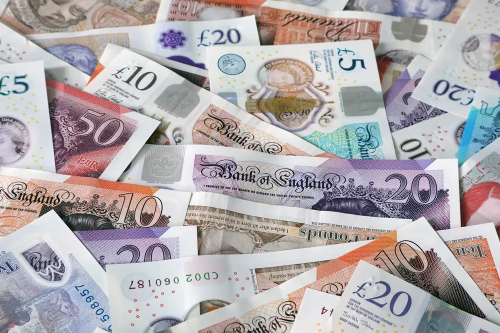 Hundreds of pounds sterling in bank notes.