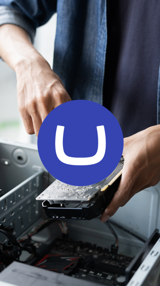 A person working on a computer upgrade, with the Umbraco logo glyph in the centre of the photo