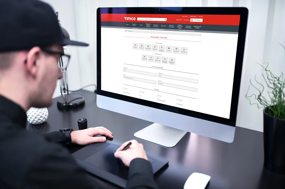 The TIMCO "My Account" webpage open on a desktop monitor in a home office.