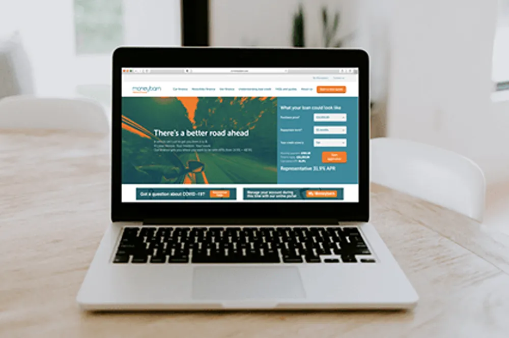 A laptop with the Moneybarn website open on it.