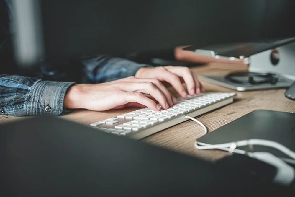 A Cold Banana employee typing at their desk.