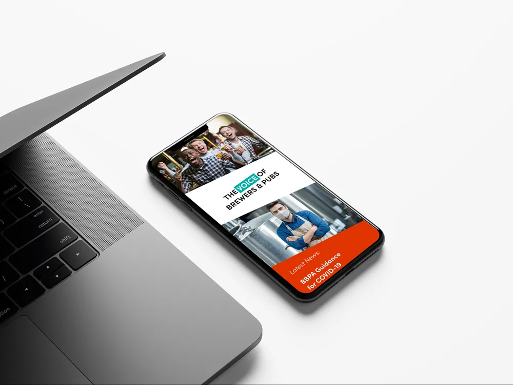 BBPA Guidance for Covid-19 webpage open on a smartphone device, with a laptop to the left