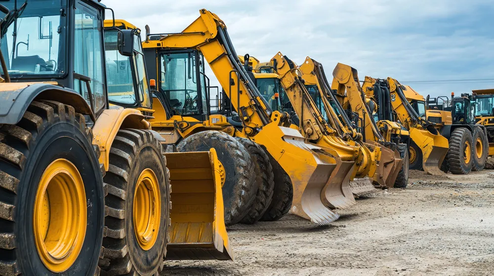 Yellow digger vehicles lined up in a row
