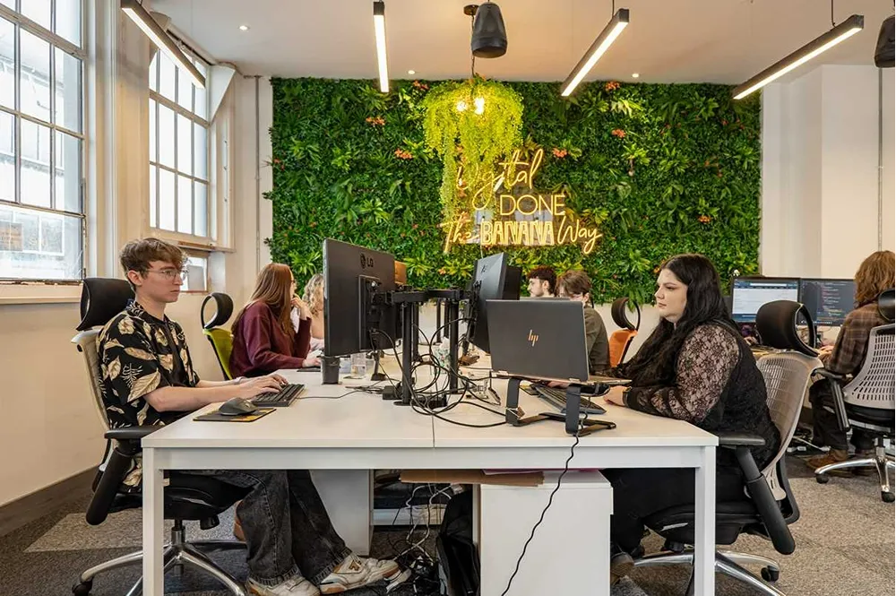 Cold Banana HQ office with employees working at their desks.