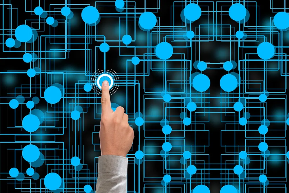 A person pointing at a node amongst an interconnected series of nodes.
