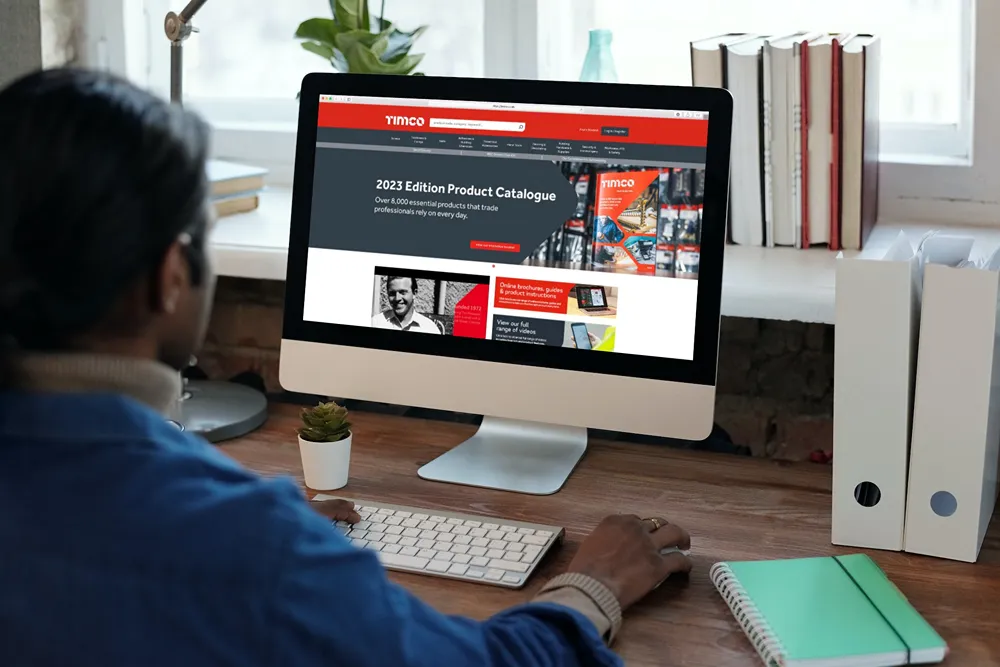 TIMCO Homepage on a desktop monitor in an office.